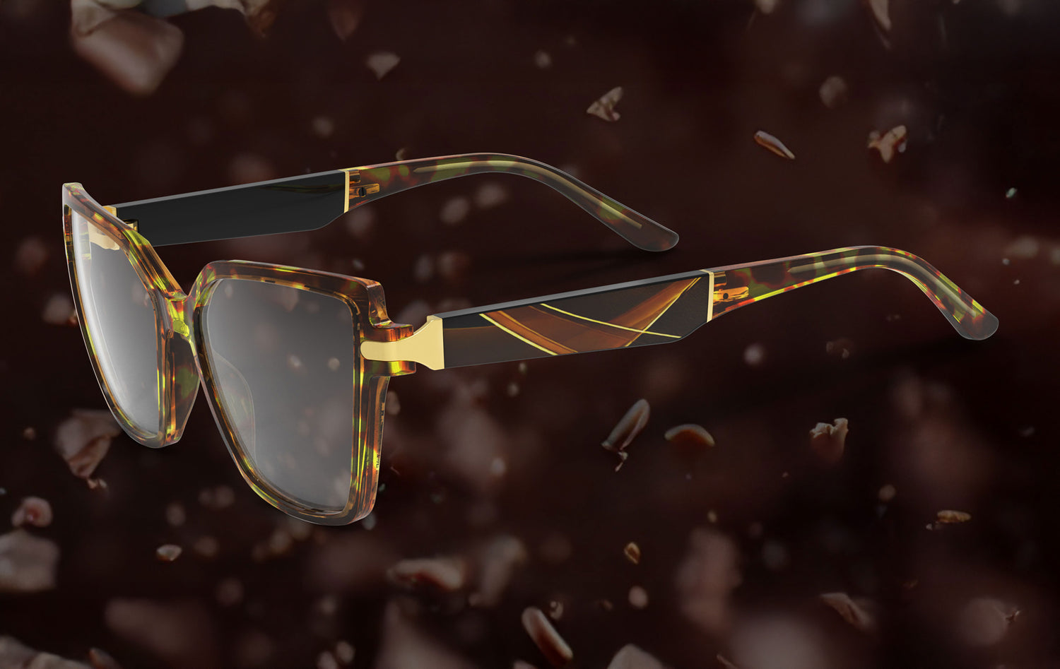 Sunglasses with a gold and brown frame on a dark background