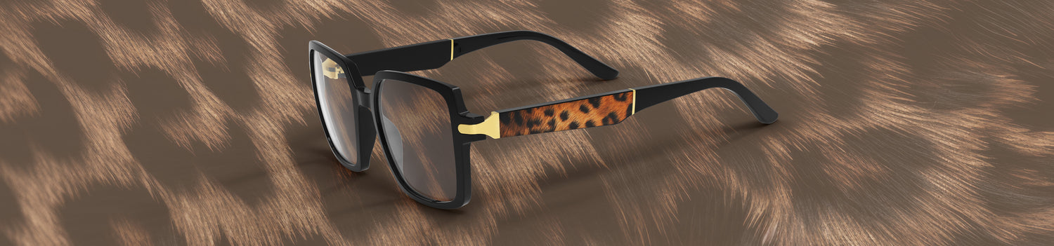 Sunglasses with a leopard print arm on a textured brown background