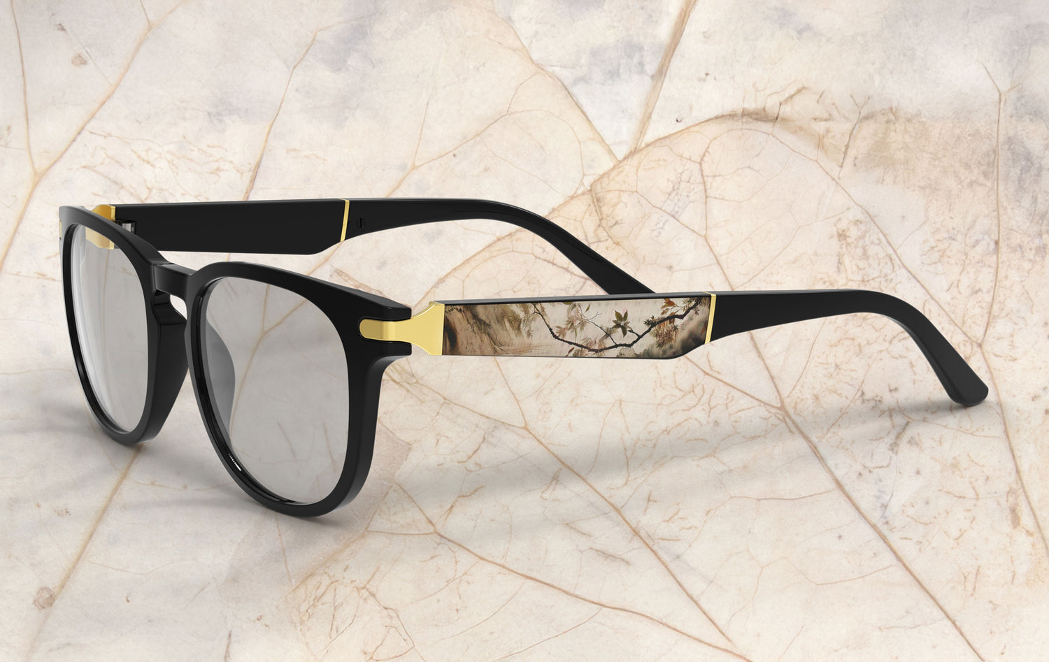 Black and gold eyeglasses on a textured beige background