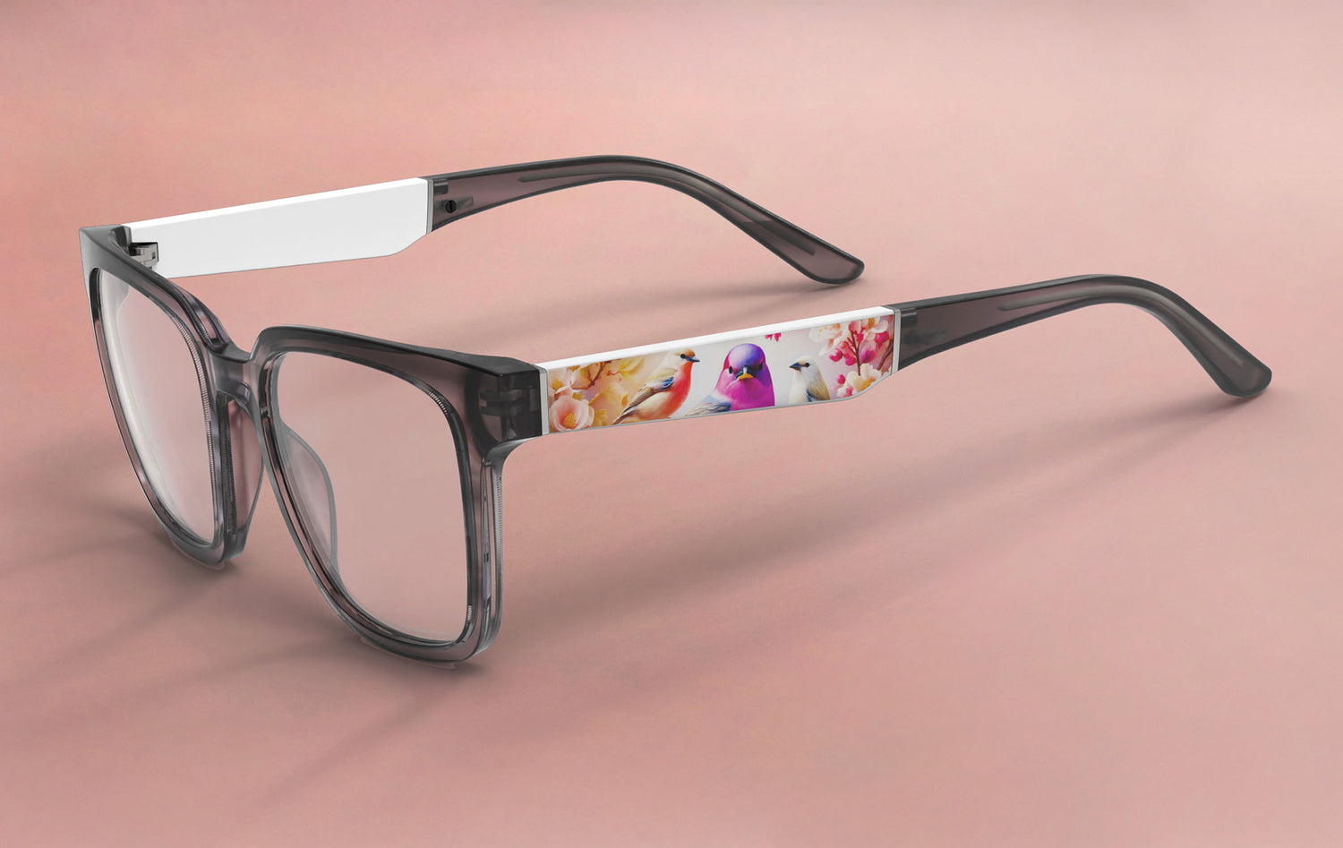 Glasses with a colorful floral design on the arm against a pink background