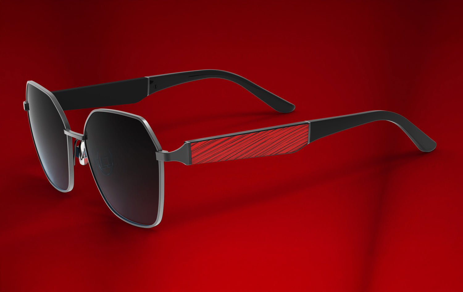 Sunglasses with black frames and dark lenses on a red background
