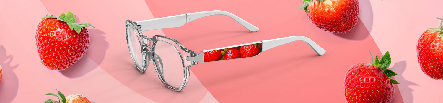 Sunglasses with strawberry pattern surrounded by strawberries on a pink background