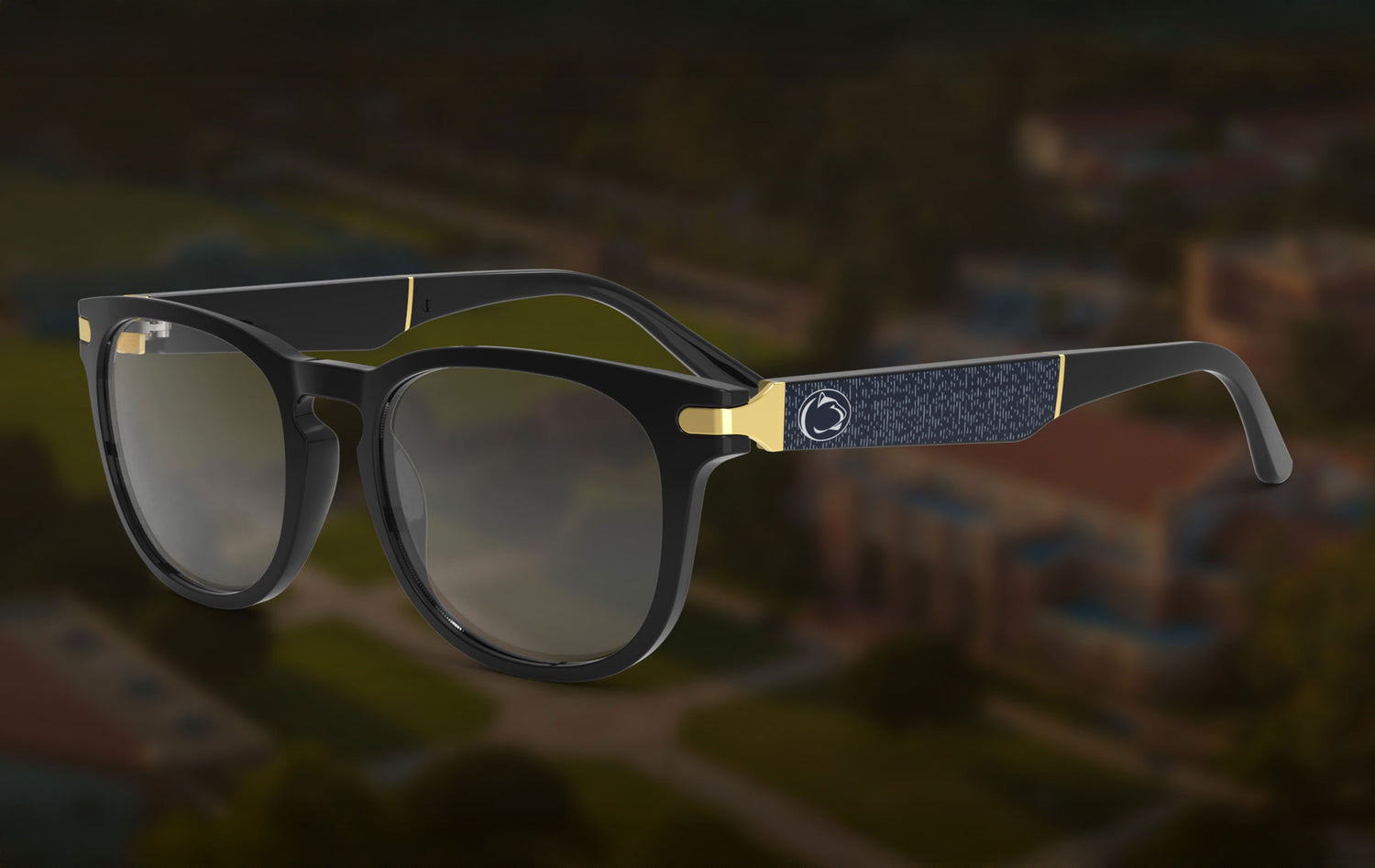 Sunglasses with black and gold frame on a blurred cityscape background