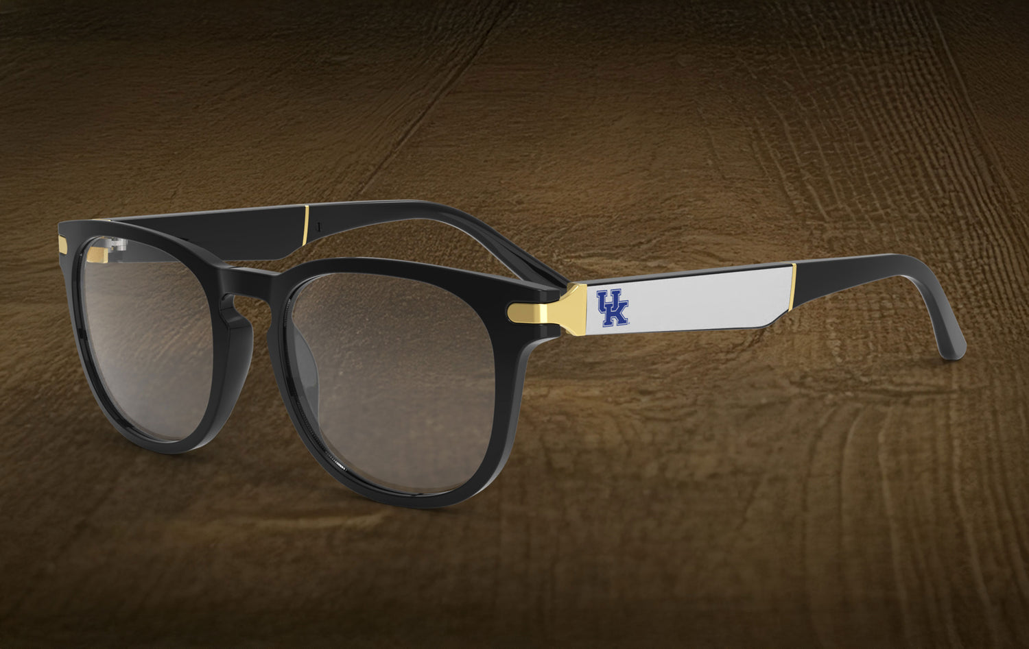 Sunglasses with a logo on the arm against a wooden background