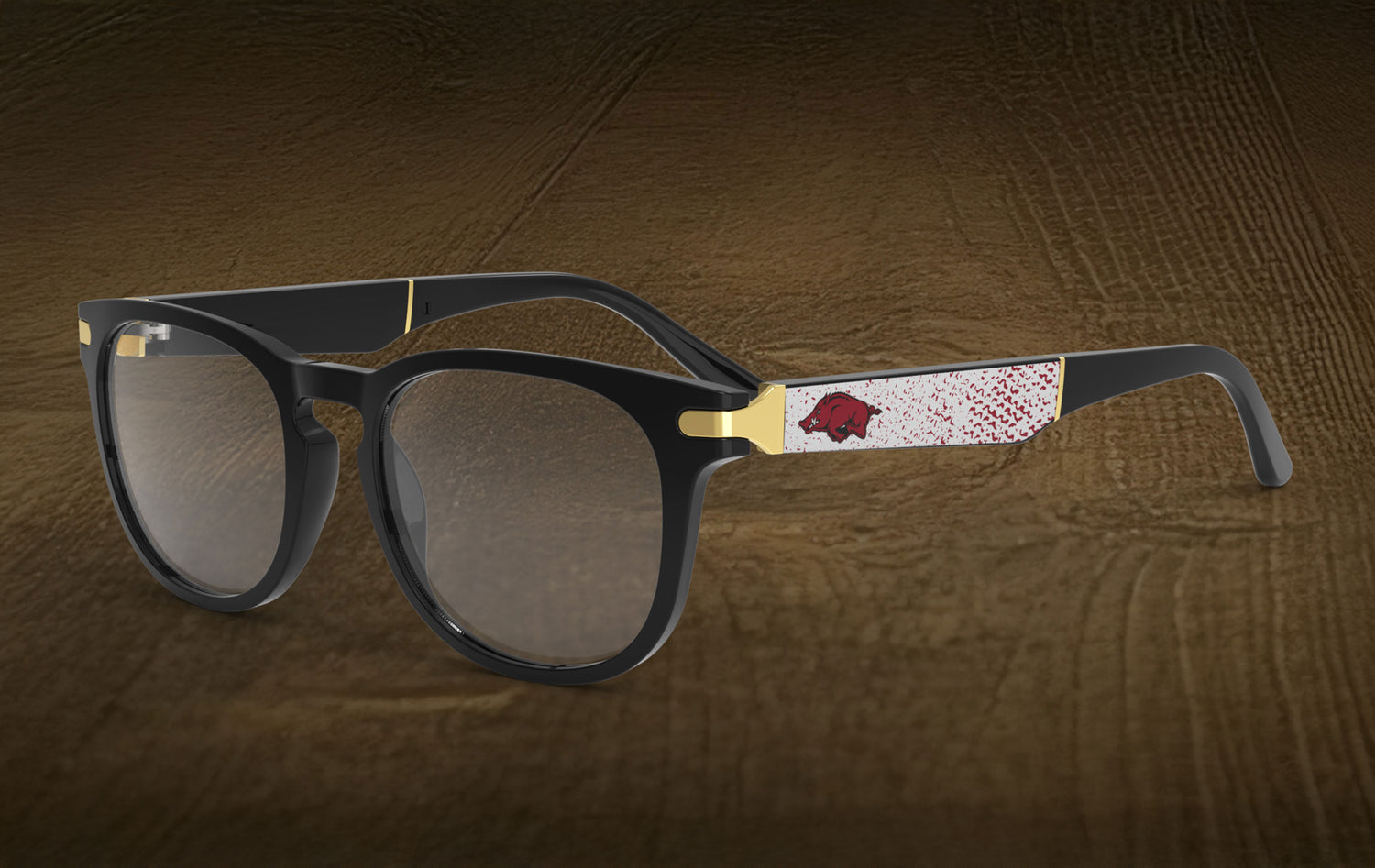 Sunglasses with a distinctive logo on a wood floored background