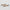 Two decorative rectangular objects with black and beige patterns on a gray background