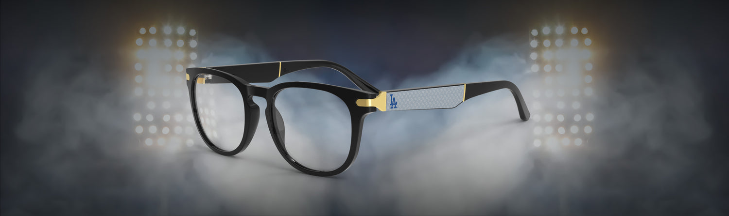 Black eyeglasses with gold accents on a dark background