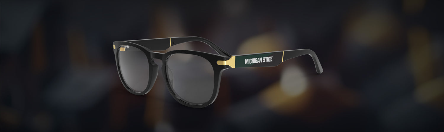 Glasses with gold accents on a blurred background