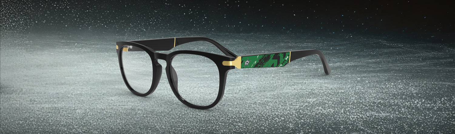 Allegiant glasses with temple blade showing Dallas Stars logo against a black and green abstract design in a hockey rink setting.