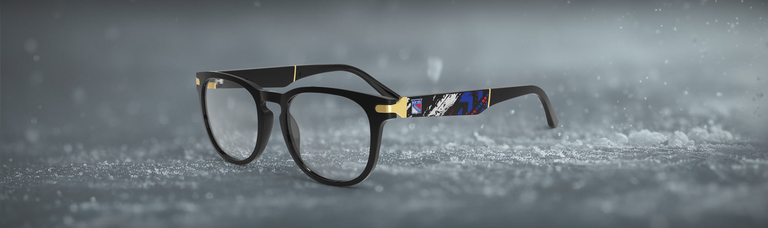 Black eyeglasses with decorative elements on a snowy background