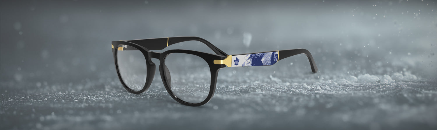 Black eyeglasses with decorative blade on a snowy background