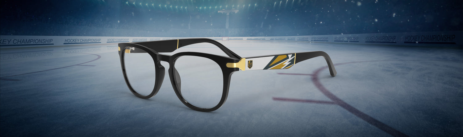 Eyeglasses with a gold accent on an ice hockey rink
