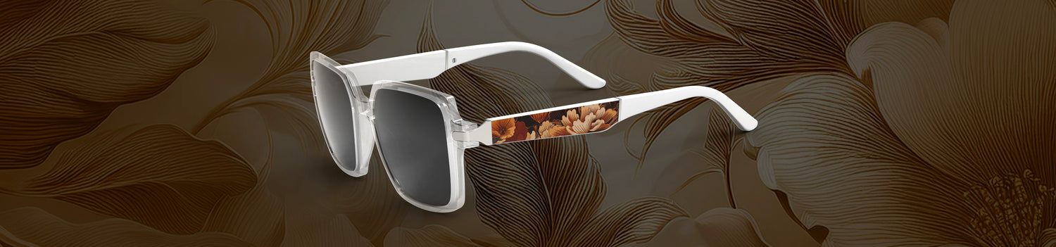 White Allegiant sunglasses with floral patterned arms on a brown floral background