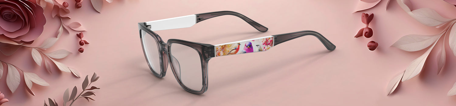Glasses with floral design on a pink background with flowers and leaves