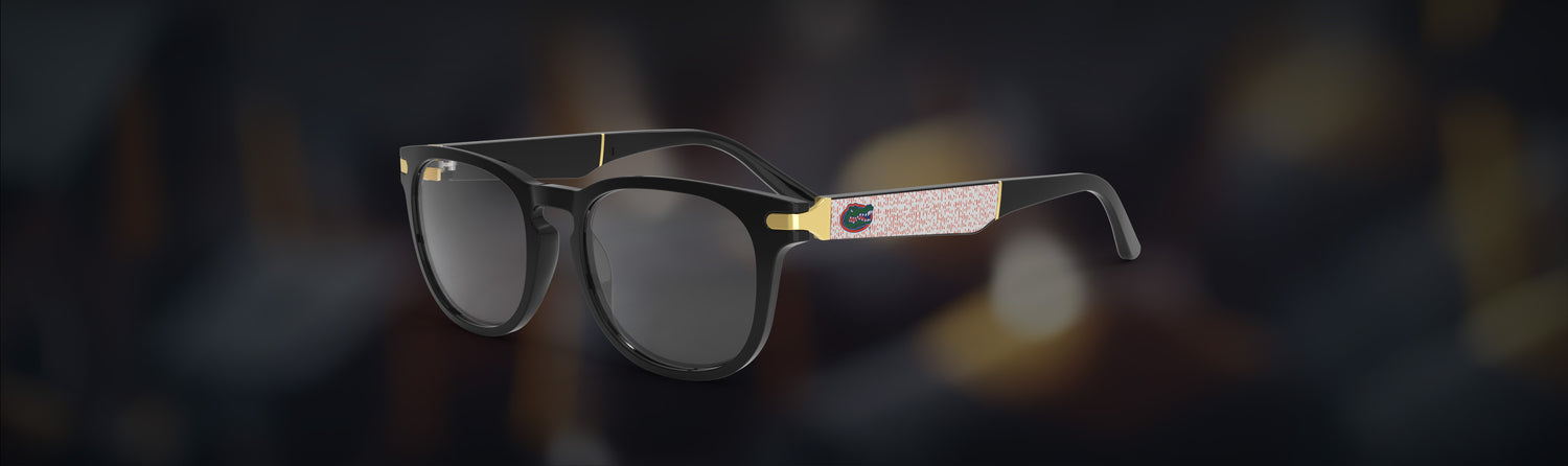Glasses with gold accents on a dark background