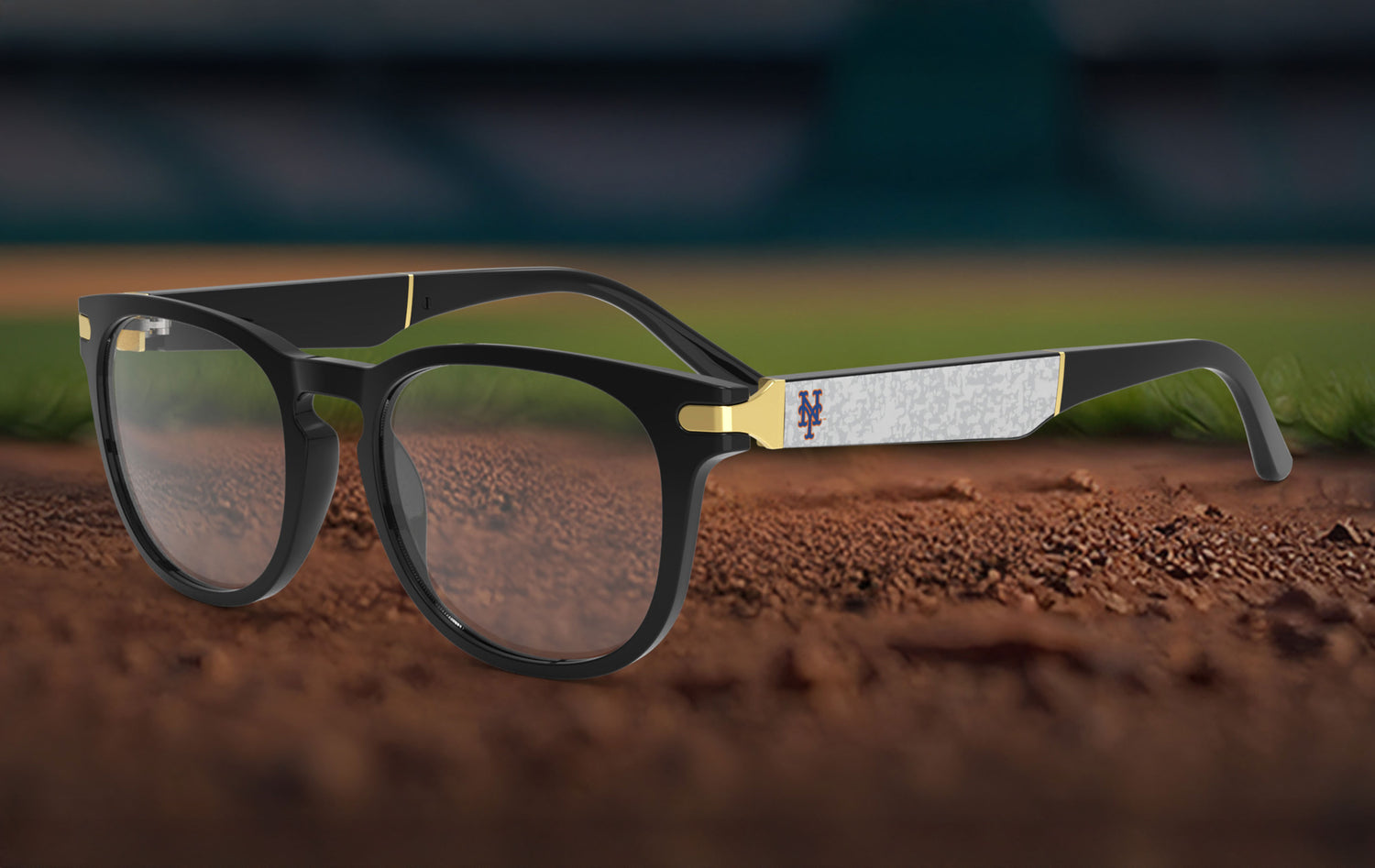 Black-framed glasses with gold accents on a baseball field