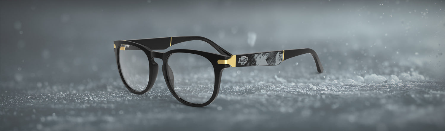 Allegiant glasses with temple blade showing Los Angeles Kings logo against a black and grey abstract design in a hockey rink setting.
