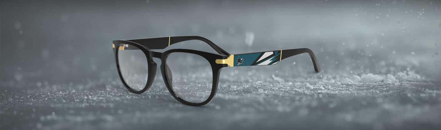 Allegiant glasses with temple blade showing San Jose Sharks logo against a black and green abstract design in a hockey rink setting.