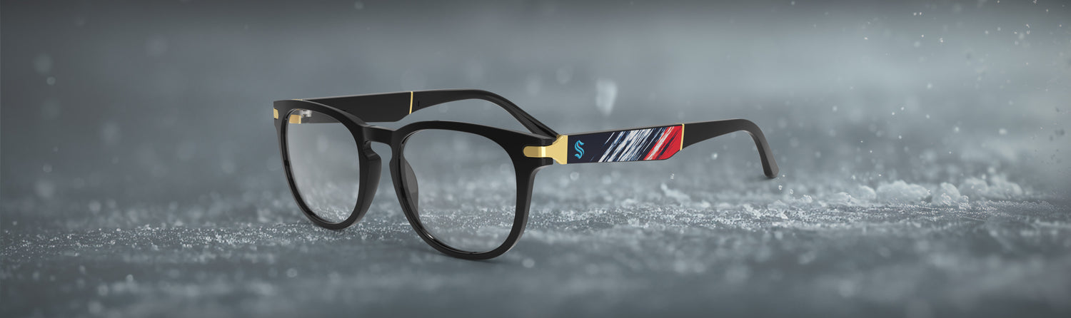 Black eyeglasses with colorful accents on a snowy surface and background