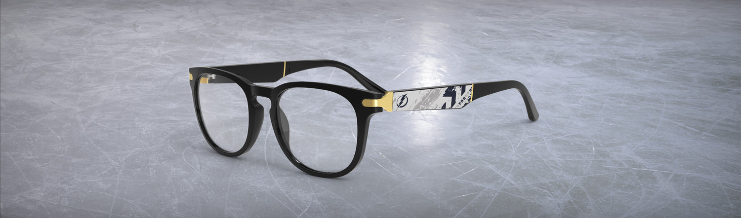 Allegiant glasses with temple blade showing Tampa Bay Lightning logo against a black and grey abstract design in a hockey rink setting.