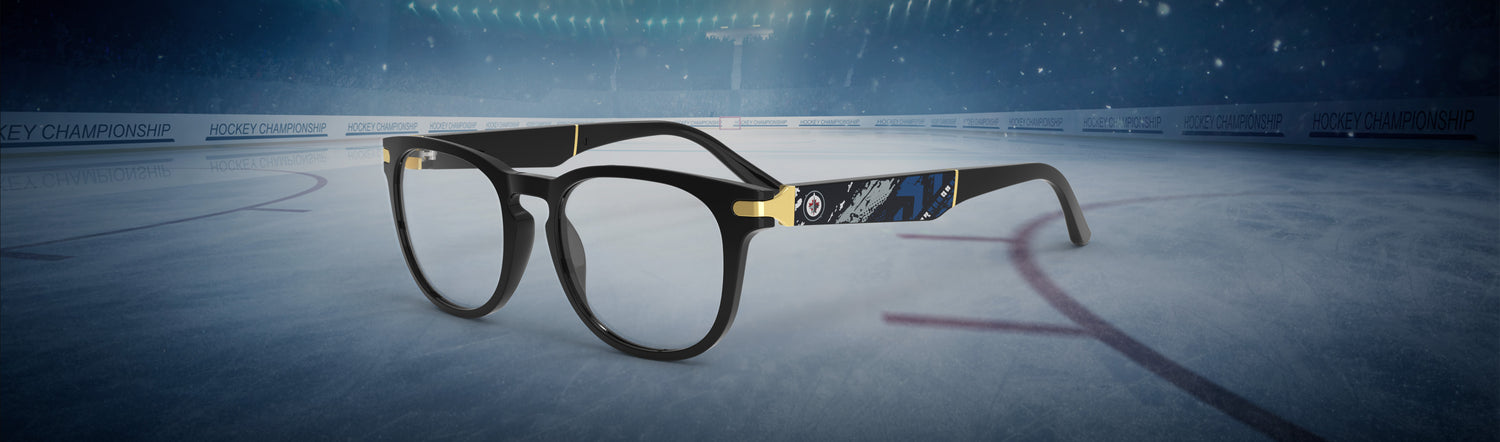 Allegiant glasses with temple blade showing Winnipeg Jets logo against a black and blue abstract design in a hockey rink setting.